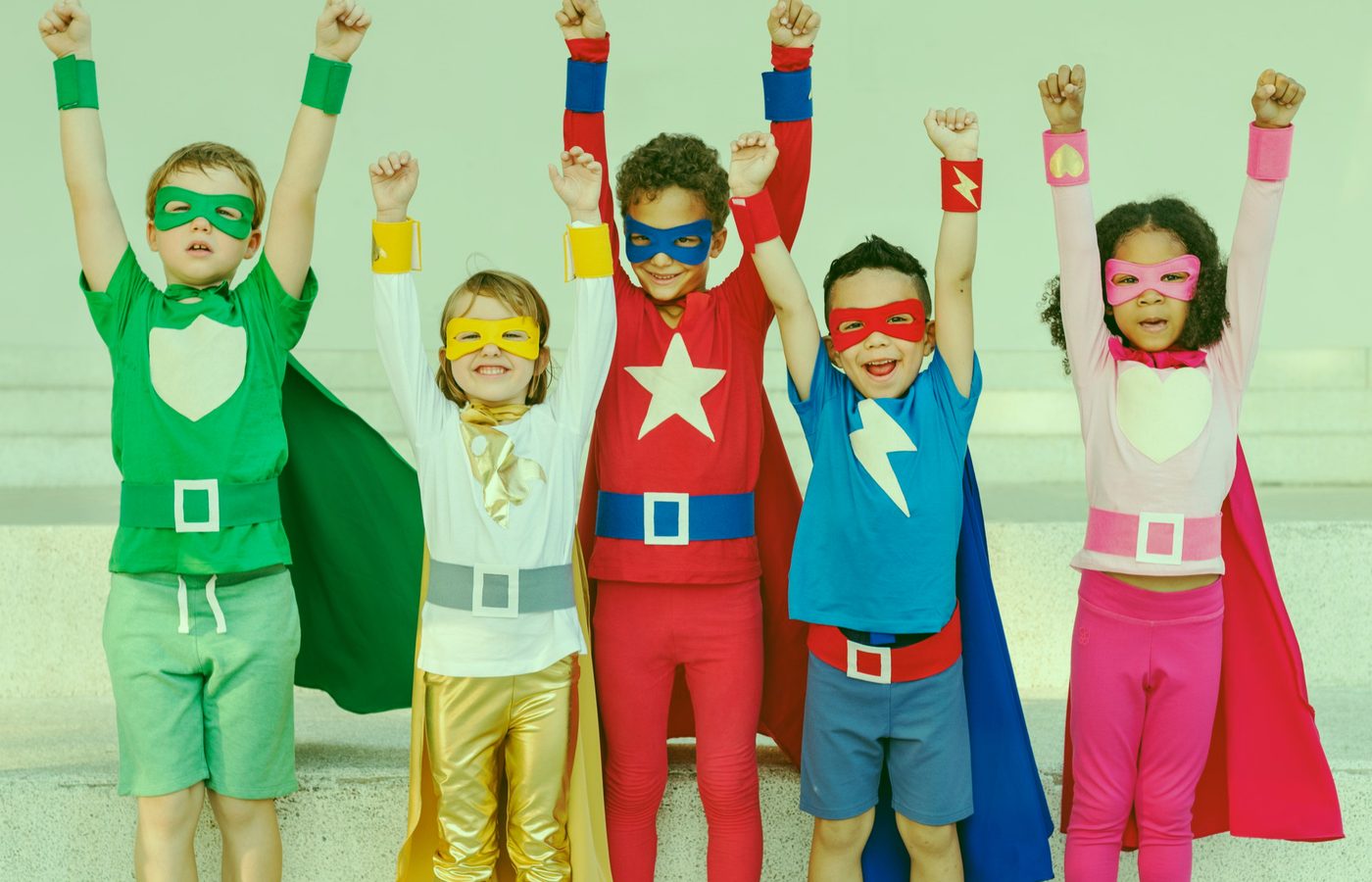 Children celebrating together dressed as superheroes